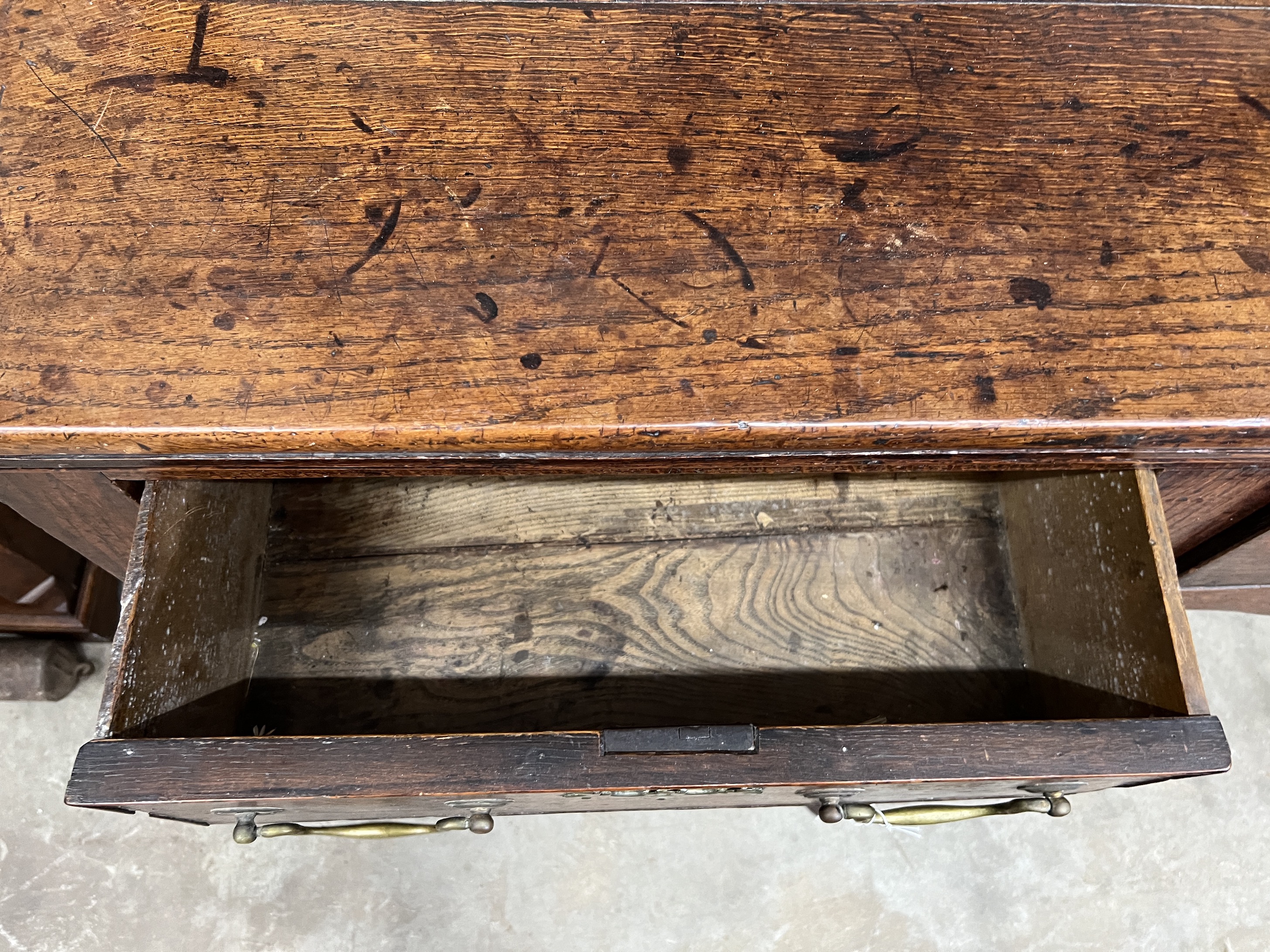 An 18th century oak dresser, with open rack and three frieze drawers, width 180cm, depth 46cm, height 180cm